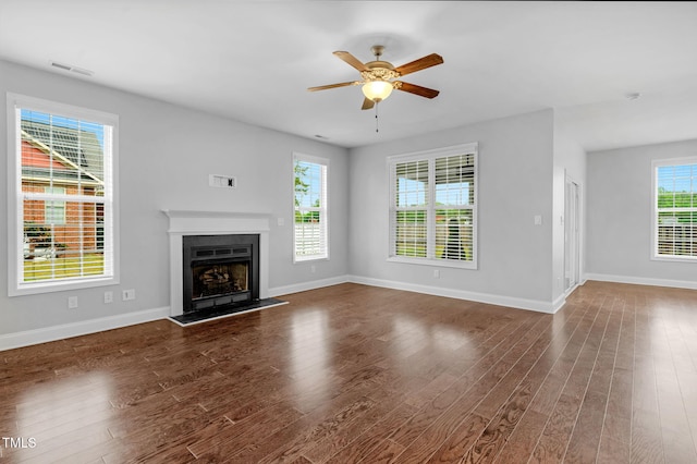 2808 Sand Trap Ln, Hope Mills, NC 28348 - unfurnished living room with ceiling fan, baseboards, dark wood-style floors, and a fireplace with raised hearth