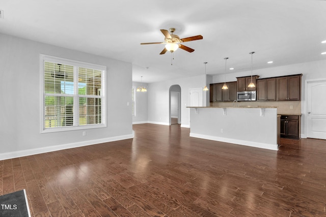 2808 Sand Trap Ln, Hope Mills, NC 28348 - unfurnished living room with ceiling fan, arched walkways, dark wood-style floors, baseboards, and recessed lighting