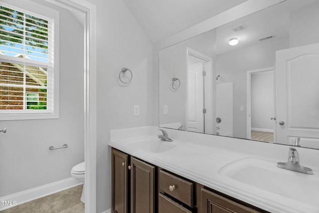 2808 Sand Trap Ln, Hope Mills, NC 28348 - bathroom with lofted ceiling, toilet, double vanity, and baseboards