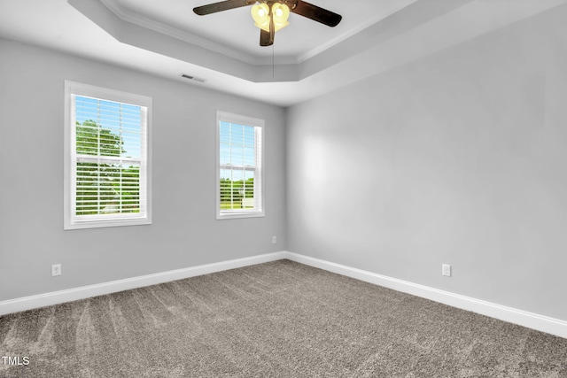 2808 Sand Trap Ln, Hope Mills, NC 28348 - carpeted empty room featuring a tray ceiling, plenty of natural light, baseboards, a ceiling fan, and ornamental molding