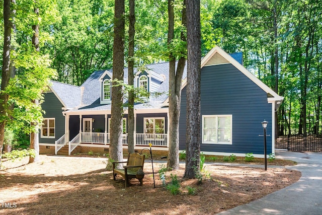 view of front facade featuring covered porch, crawl space, and a shingled roof