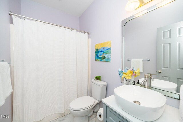 full bath with marble finish flooring, toilet, vanity, and curtained shower