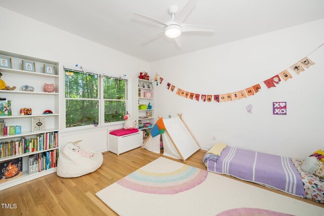 bedroom with wood finished floors, baseboards, and ceiling fan