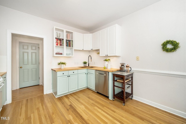 kitchen with dishwasher, wallpapered walls, wooden counters, baseboards, and light wood-type flooring