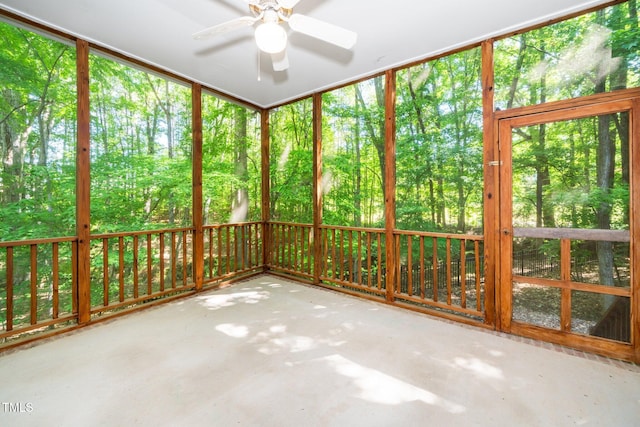 unfurnished sunroom with ceiling fan