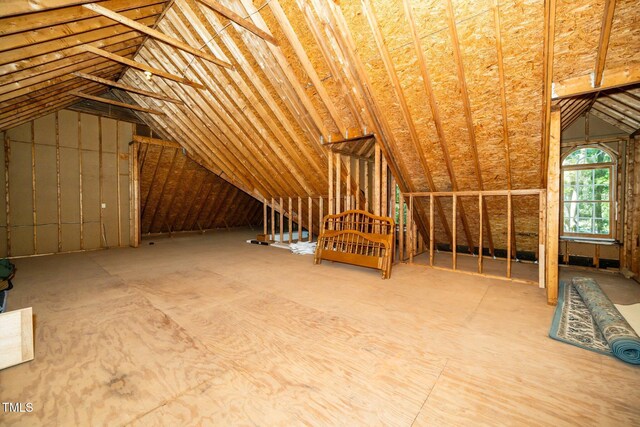 unfinished attic featuring an upstairs landing