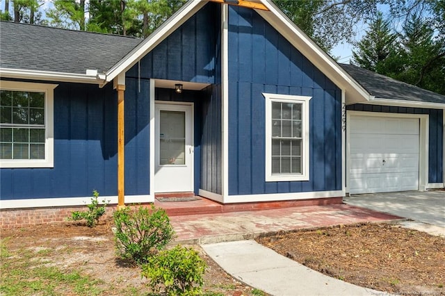 entrance to property with a garage and roof with shingles