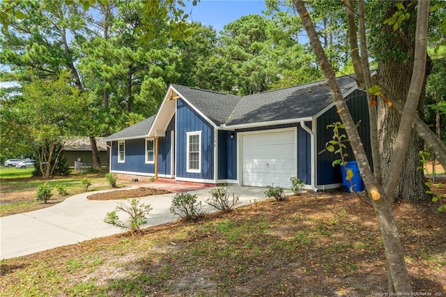 single story home featuring a garage, concrete driveway, and roof with shingles