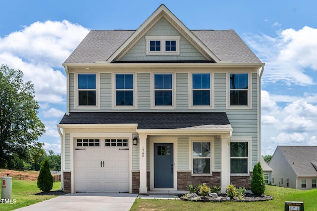 1745 Ripley Woods St, Wake Forest, NC 27587 - craftsman-style home with concrete driveway, a shingled roof, a front yard, stone siding, and a garage