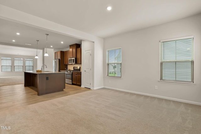 1745 Ripley Woods St, Wake Forest, NC 27587 - kitchen featuring stainless steel appliances, open floor plan, light carpet, a kitchen island with sink, and recessed lighting