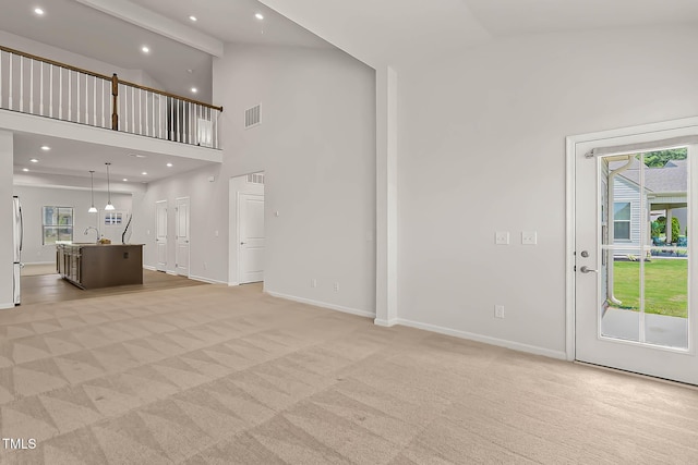 1745 Ripley Woods St, Wake Forest, NC 27587 - unfurnished living room with light carpet, high vaulted ceiling, and recessed lighting