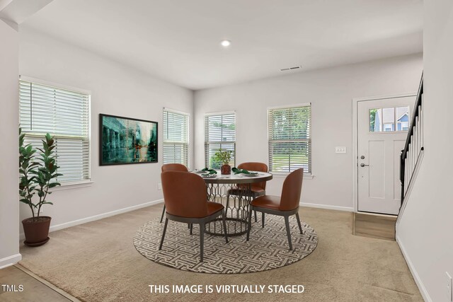 1745 Ripley Woods St, Wake Forest, NC 27587 - dining area with plenty of natural light, light colored carpet, stairs, and recessed lighting