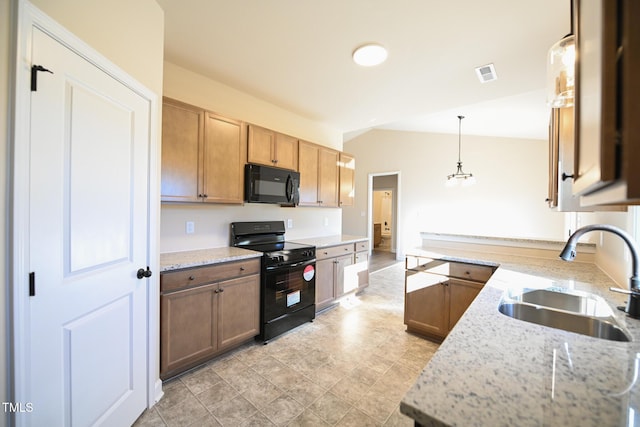 kitchen featuring black appliances, a sink, lofted ceiling, decorative light fixtures, and light stone counters
