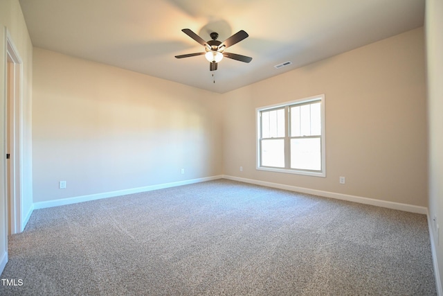 carpeted empty room featuring a ceiling fan and baseboards