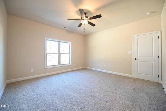 unfurnished room featuring a ceiling fan, light carpet, baseboards, and a smoke detector