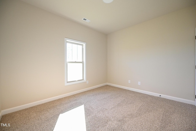 carpeted spare room featuring baseboards