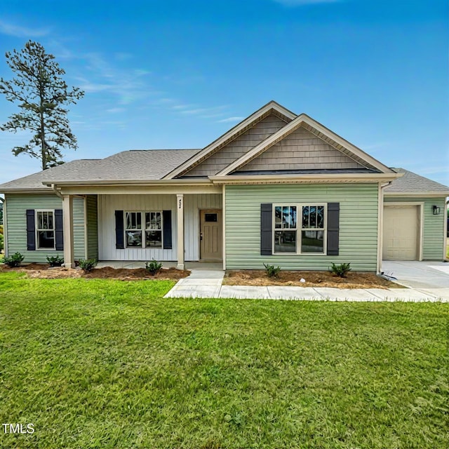 view of front of home with an attached garage, a front lawn, driveway, and board and batten siding