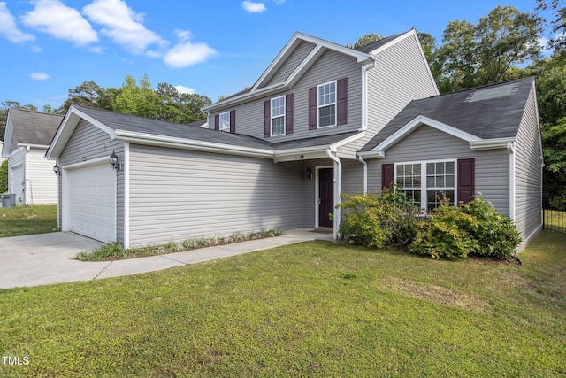 traditional-style house featuring driveway, a garage, and a front yard