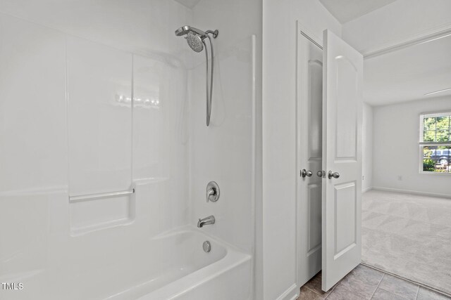 full bath with shower / washtub combination, baseboards, and tile patterned flooring