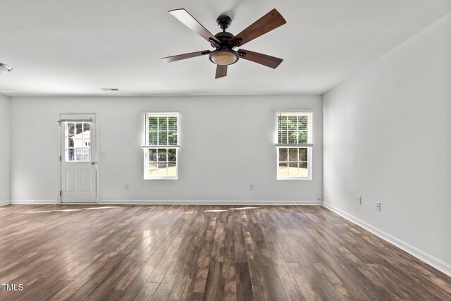 empty room featuring wood finished floors, ceiling fan, and baseboards