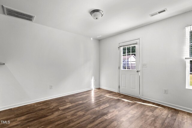 empty room with wood finished floors and baseboards