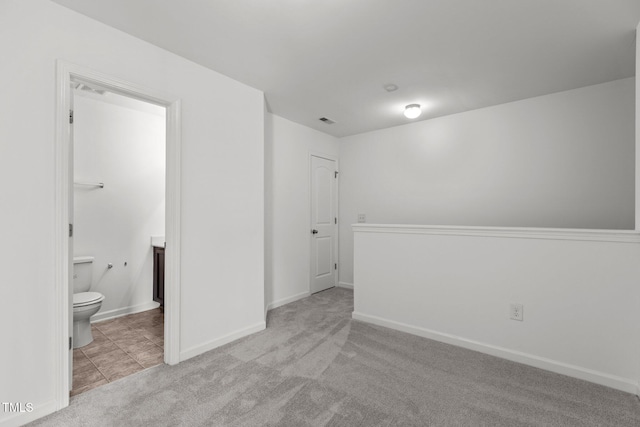 carpeted empty room with baseboards