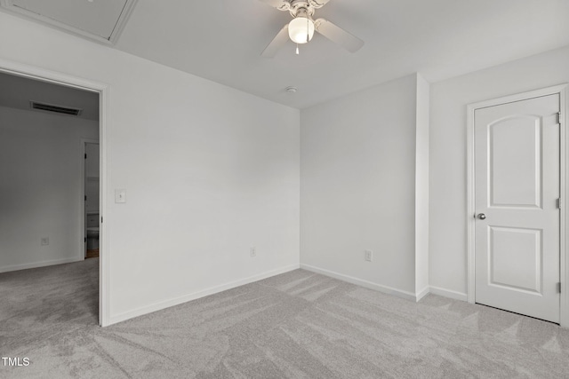 carpeted empty room with ceiling fan and baseboards
