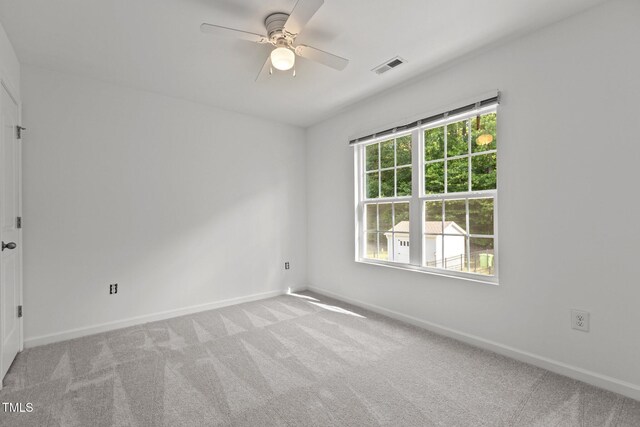 unfurnished room with baseboards, carpet, and a ceiling fan