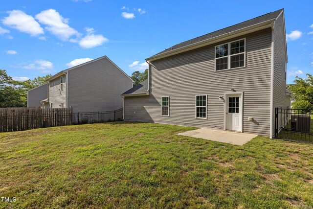 back of house with a patio area and central AC