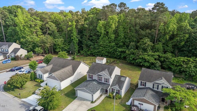 aerial perspective of suburban area featuring a forest