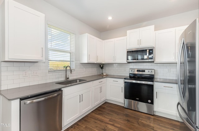19 Cecina Ct, Clayton, NC 27527 - kitchen with stainless steel appliances, a sink, dark countertops, white cabinets, and recessed lighting