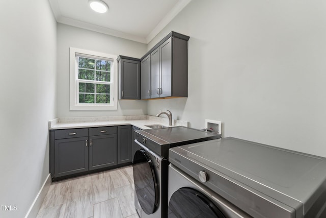 laundry room with cabinet space, crown molding, independent washer and dryer, and baseboards