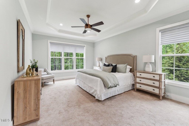 bedroom with multiple windows, light carpet, a raised ceiling, crown molding, and recessed lighting