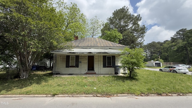 752 Nashville Rd, Rocky Mount, NC 27803 - bungalow with covered porch, a front yard, and a chimney