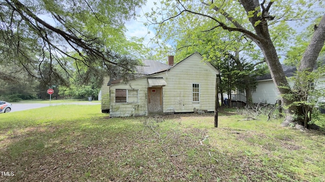 752 Nashville Rd, Rocky Mount, NC 27803 - view of side of home featuring a chimney and a lawn
