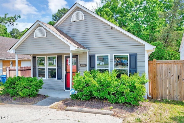 bungalow featuring fence and a porch