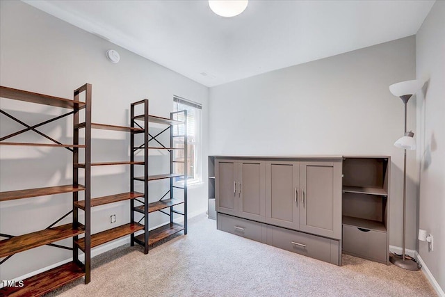 unfurnished bedroom with light carpet and baseboards