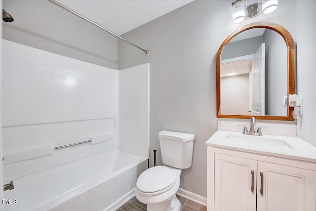 full bathroom featuring toilet,  shower combination, vanity, and baseboards