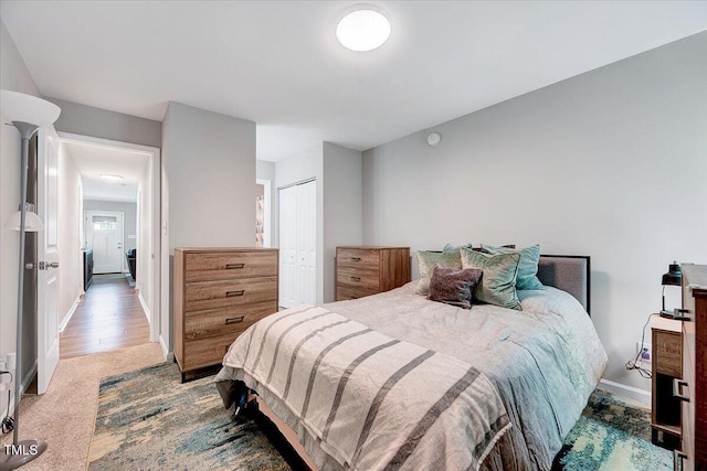 bedroom featuring baseboards and a closet
