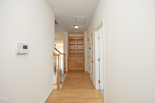 corridor featuring light wood finished floors