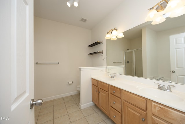 full bathroom with tile patterned floors, a shower stall, toilet, double vanity, and baseboards