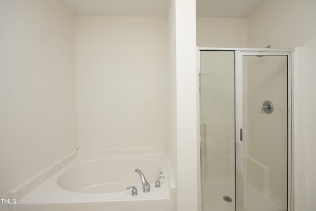 bathroom with a garden tub and a shower stall