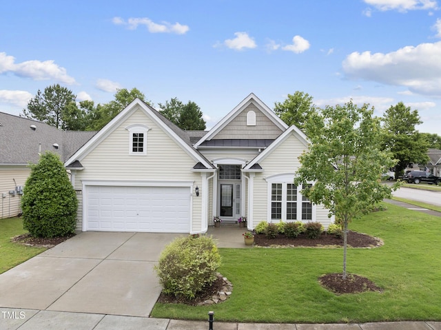 view of front of house with driveway, a front lawn, and a garage