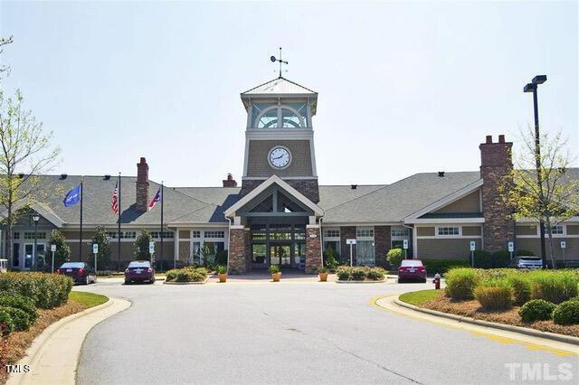 view of building exterior with uncovered parking