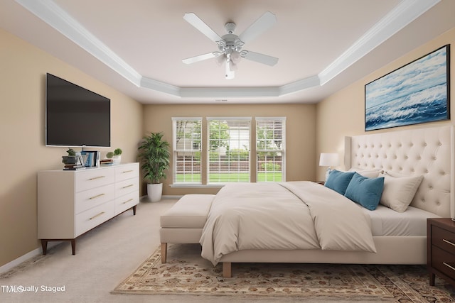 bedroom with a tray ceiling, ornamental molding, light colored carpet, ceiling fan, and baseboards