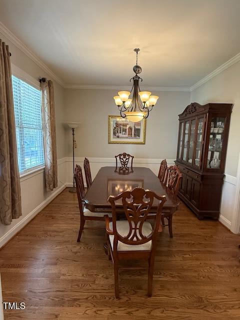 dining room featuring a chandelier, wood finished floors, and ornamental molding