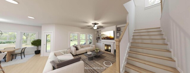 1891 Ballard Rd Unit 192, Fuquay Varina, NC 27526 - living room with a lit fireplace, stairs, wood finished floors, ceiling fan, and recessed lighting