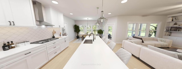 1891 Ballard Rd Unit 192, Fuquay Varina, NC 27526 - kitchen featuring a sink, wall chimney range hood, open floor plan, stainless steel gas stovetop, and recessed lighting