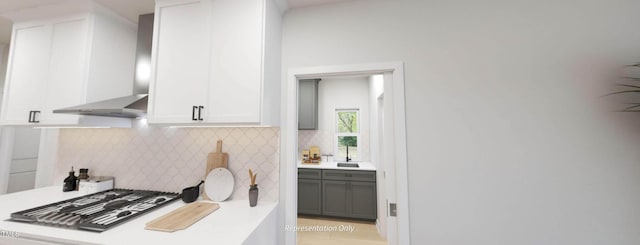 1891 Ballard Rd Unit 192, Fuquay Varina, NC 27526 - kitchen with wall chimney range hood, decorative backsplash, stainless steel gas stovetop, white cabinets, and light countertops
