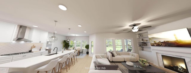 1891 Ballard Rd Unit 192, Fuquay Varina, NC 27526 - living room with a fireplace, recessed lighting, light wood-style flooring, a ceiling fan, and built in features